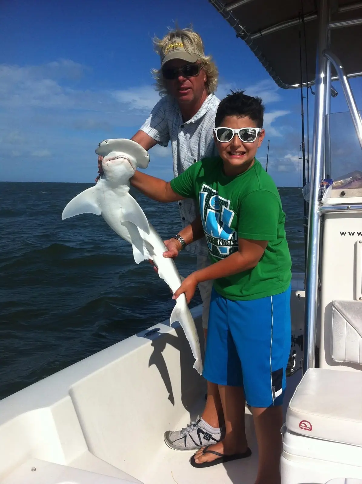 Captain Fritz helping a young angler show his catch